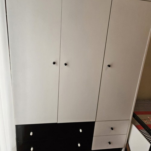 Bedroom wardrobe used with storage spaces, modern design, white doors