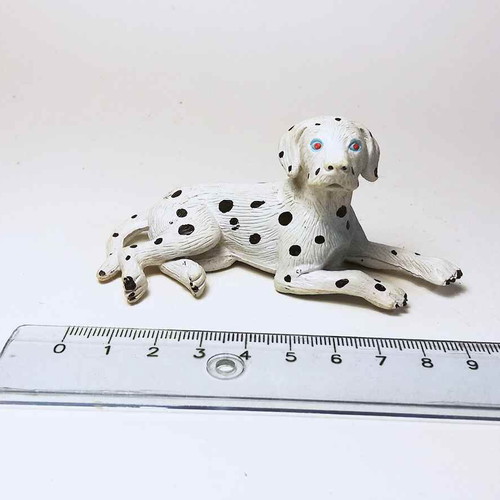Plastic dog figure used with scratches and marks