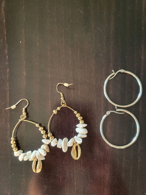 Pair of gold drop earrings with white stones and silver hoop earrings