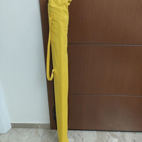 Beach umbrella used with carrying case and sand anchor