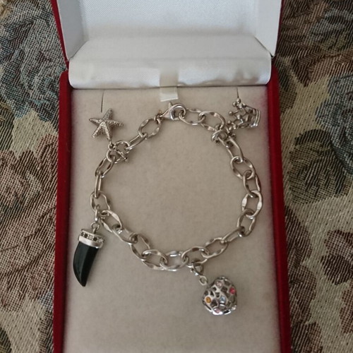 Silver bracelet with hanging charm designs like new