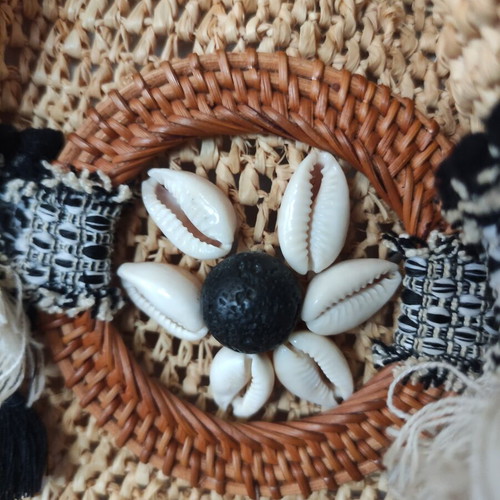 Boho straw backpack used with shells and rope straps, resort style
