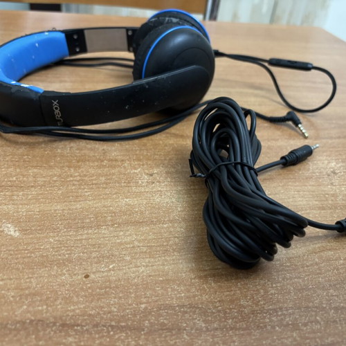 Wired headphones with 5m extension cable used, visible wear on plastic