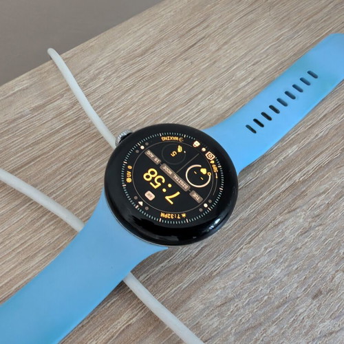Google Pixel Watch 2 with charging base and extra metallic band