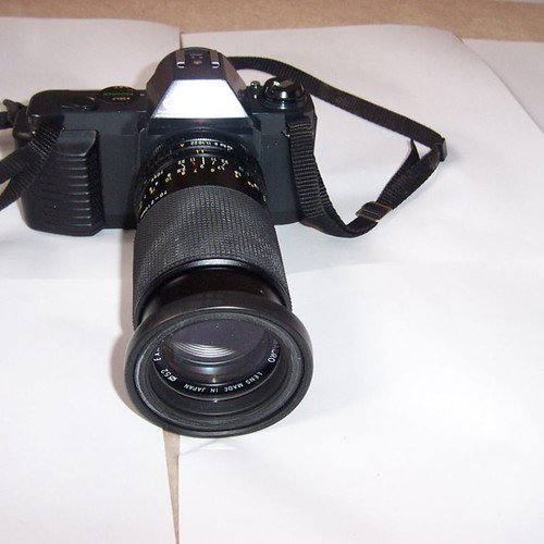 Canon T50 SLR analog camera used with two zoom lenses and flash