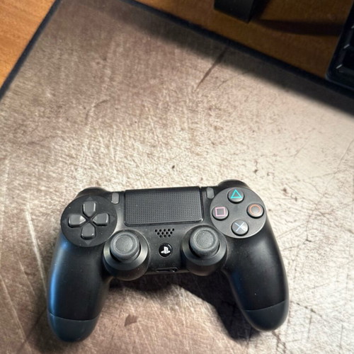 PlayStation 4 Pro used with controller and two games