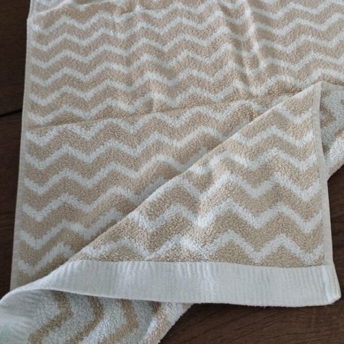Laura Ashley face towel like new with geometric pattern light blue beige