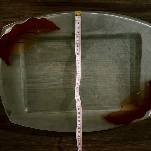 Decorative glass tray used with embossed leaf design