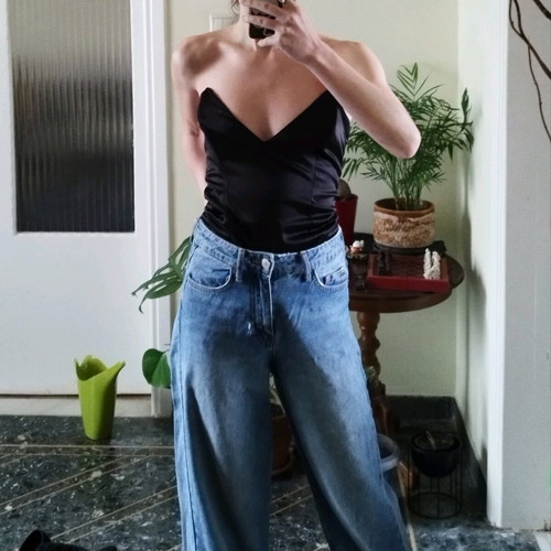 Black corset used with pointed neckline and leather look, size XS