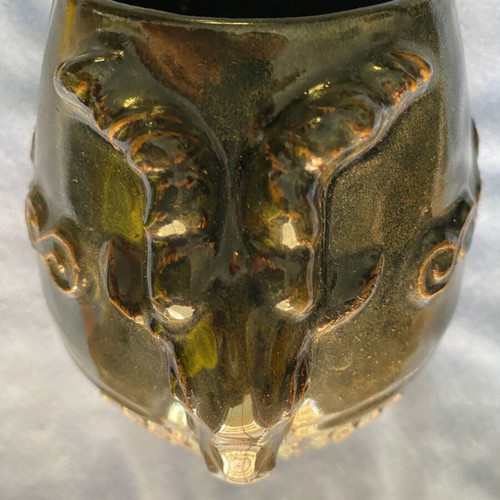 Black ceramic vase with ram’s head decoration
