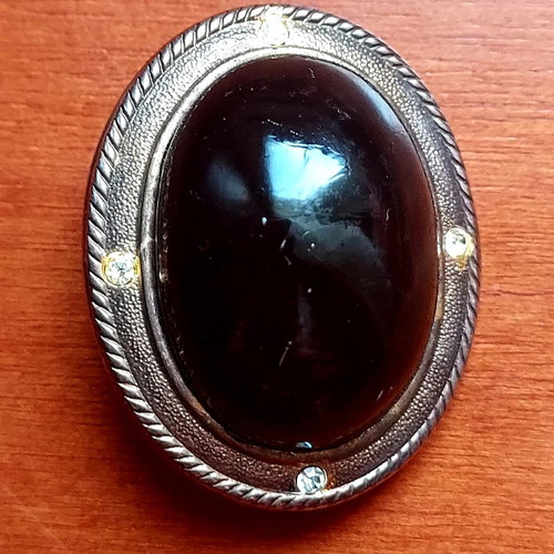 Vintage brooch used with black stone and silver frame