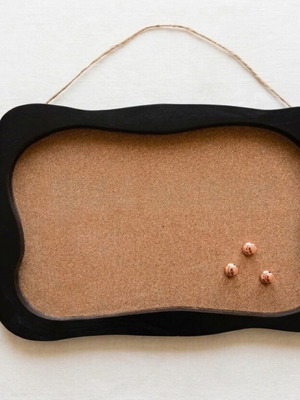 Retro cork board with wavy black wooden frame