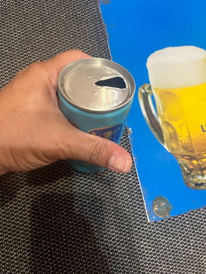 Lowenbrau tin sign and beer can used, 1980s