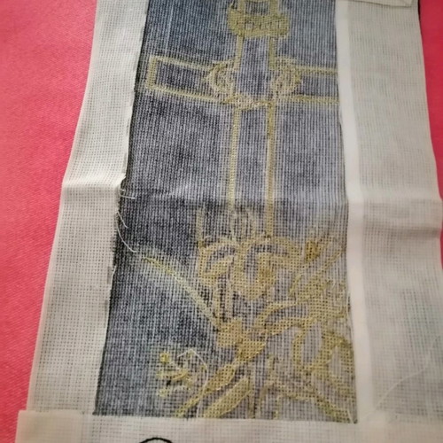 Handmade embroidered cross with gold thread on black velvet canvas