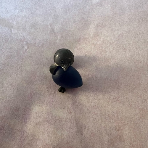 Silver penguin pin used with blue stone