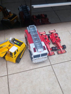 Toy cars used with working fire truck and bulldozer