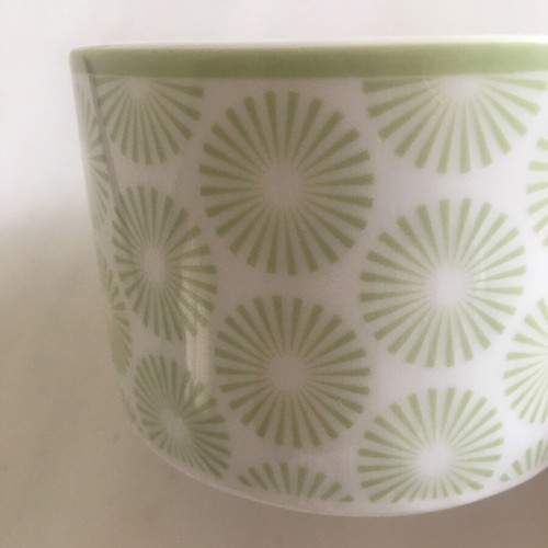 Vintage porcelain cup with light green daisy decorations like new