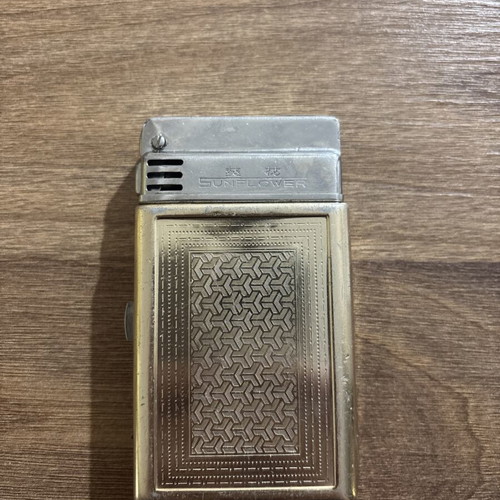 Sunflower lighter used with signs of wear, made in Shanghai