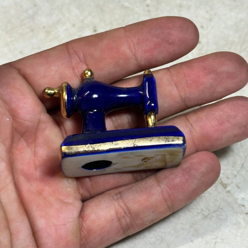 Vintage porcelain miniature sewing machine with gold details, used
