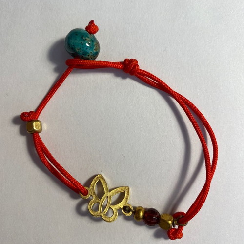 Bracelet used with red cord and butterfly bead