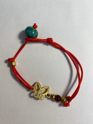 Bracelet used with red cord and butterfly bead