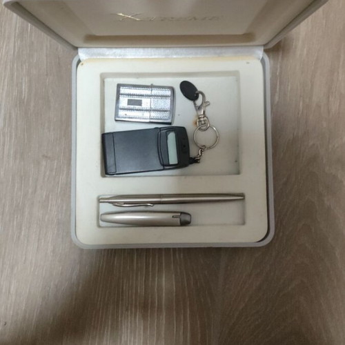 Gift set with lighters, pens, keychain, and calculator