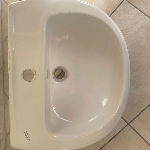White bathroom sink used with minor small marks