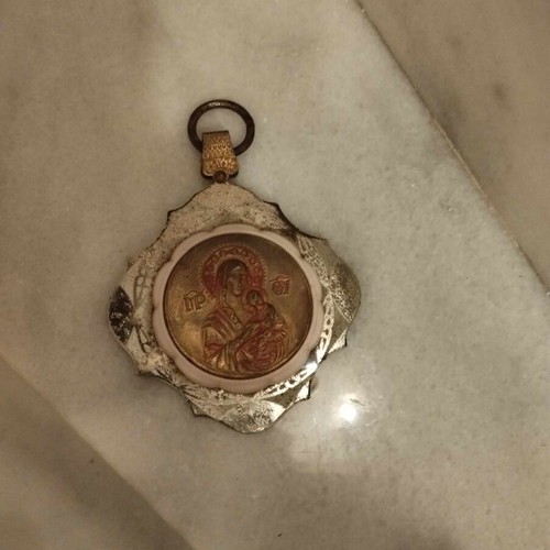 Metal pendant used with Virgin Mary and baby Jesus for car