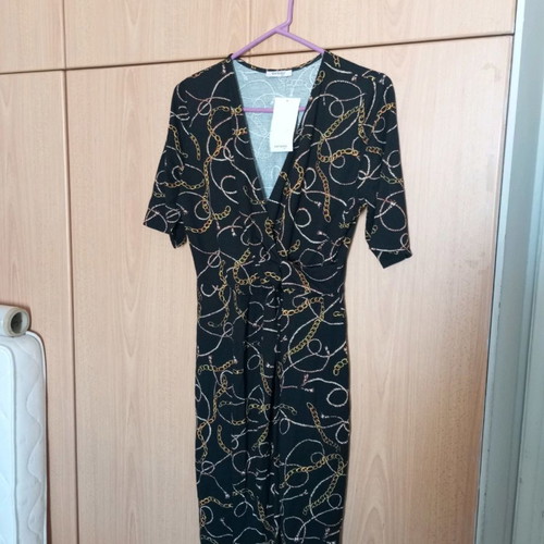 Black dress new with gold drape and pointed hem