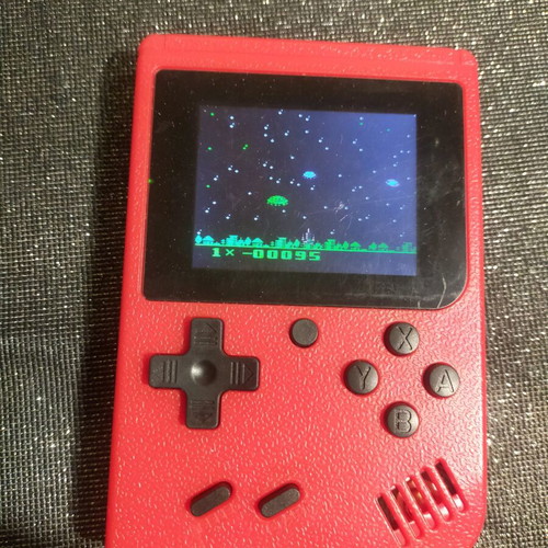 Retro style handheld game console used, working