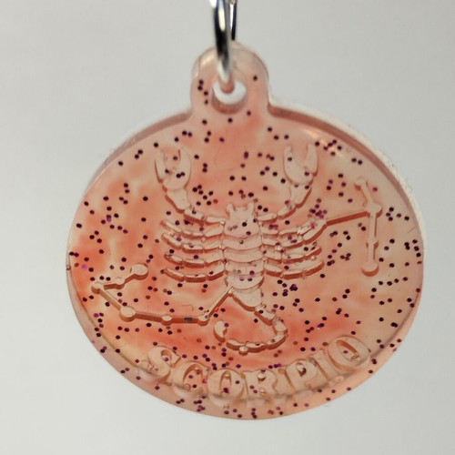Handmade pendant with zodiac sign Gemini or Scorpio in red pigment