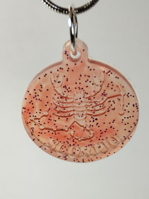 Handmade pendant with zodiac sign Gemini or Scorpio in red pigment