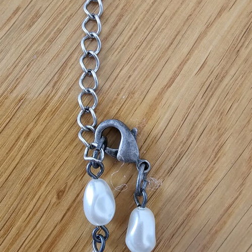 Necklace used with drop-shaped pearls and silver metal details