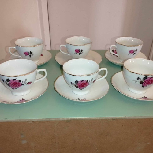 Vintage porcelain cup and saucer set with fuchsia roses