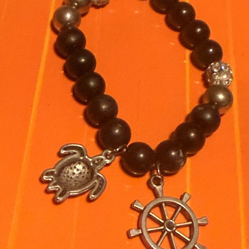 Elastic bracelet like new with steering wheel and turtle charms black-silver