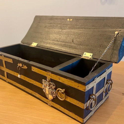 Antique wooden chest used with medieval emblem