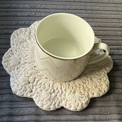 Knitted coaster used, flower-shaped, beige