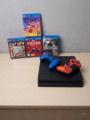 PlayStation 4 Slim 500GB console with controllers and games
