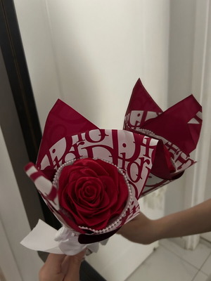 Red artificial ribbon flower with red and white wrapping handmade