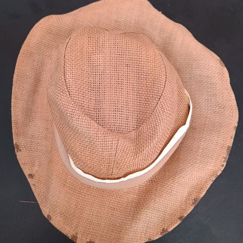 Straw-like hat used, tan with marks