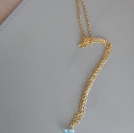 Necklace new with dangling light blue beads on gold