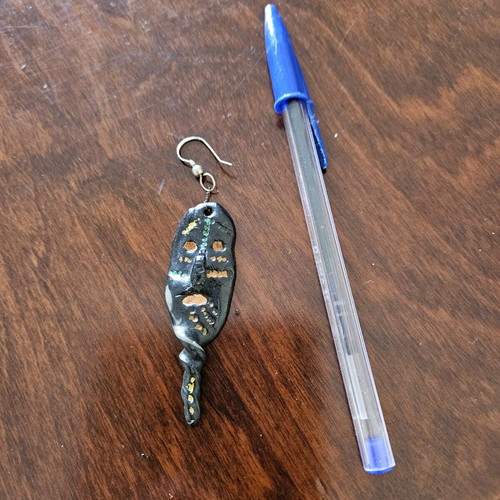 Black earring used, totem-inspired with multicolor pattern