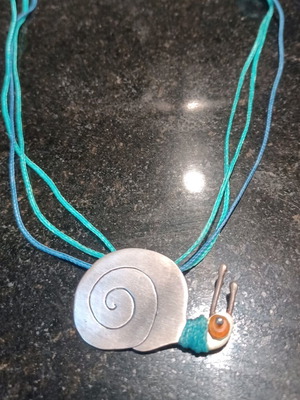 Snail necklace like new, metal with blue cords
