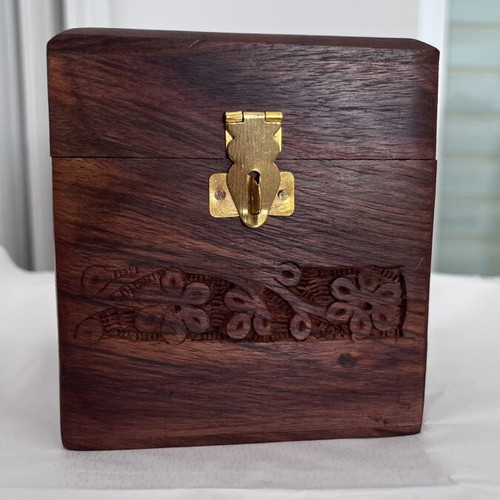 Wooden coin box with brass clip and carved design