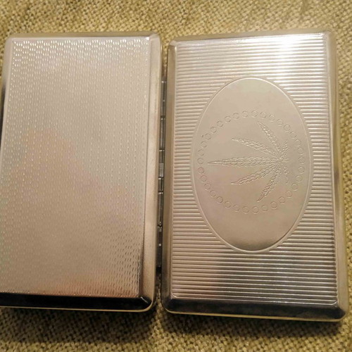 Tobacco case and metal cigarette roller used