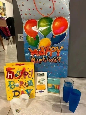 Birthday party supplies like new, gift bags, cups, candles