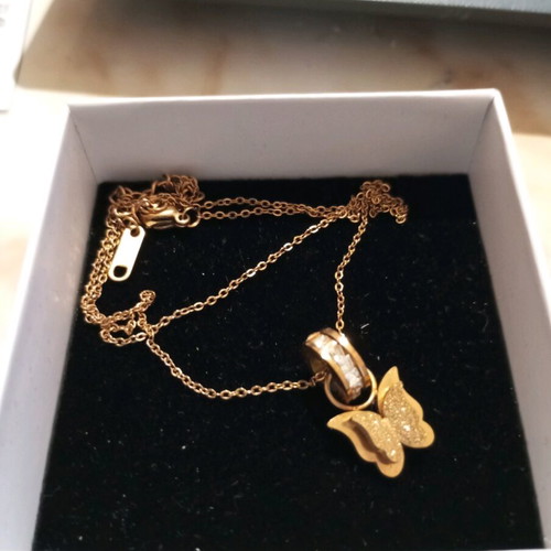 Steel necklace gold color with butterfly design and rhinestone ring