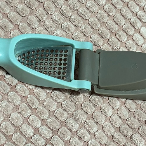 Garlic press used with ergonomic handle and easy cleaning