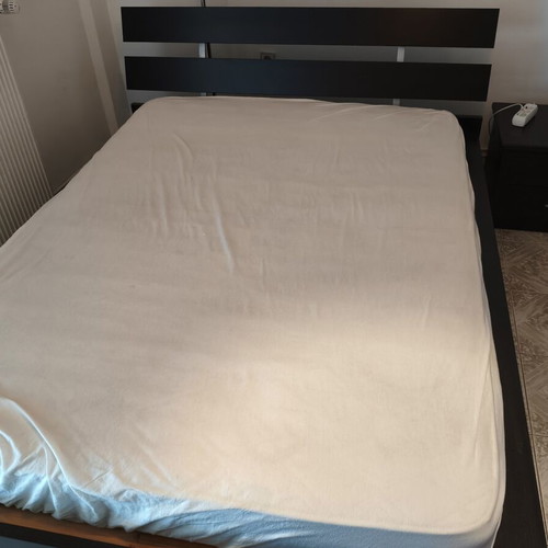 Complete dark wood bedroom set with double bed and bedside table