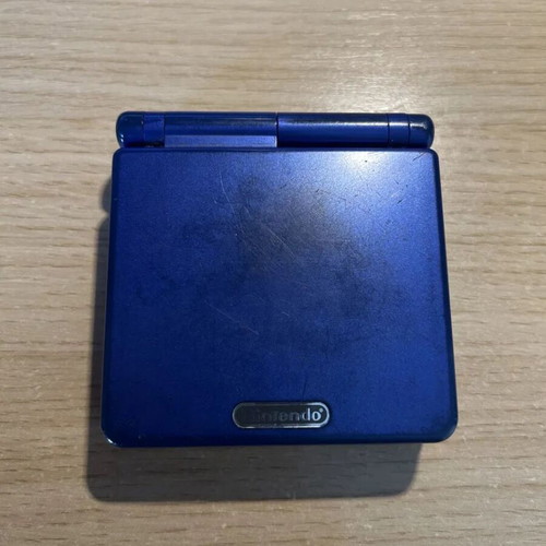 Game Boy Advance SP cobalt blue used with charger and NES Classics cartridge